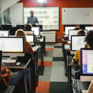 People using computers in a classroom