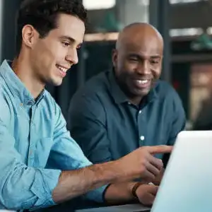 People using computers in a workplace